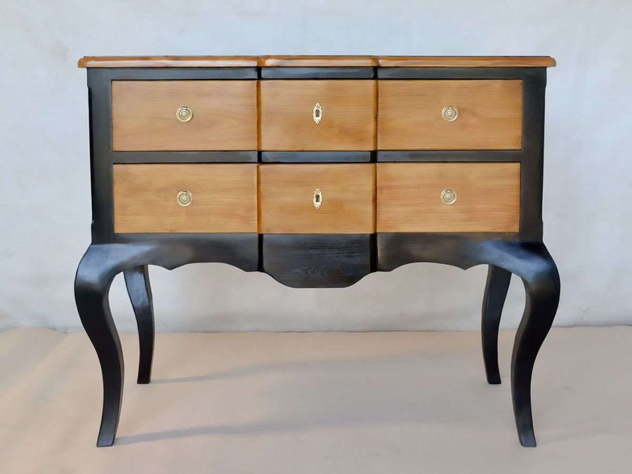 Natural wood front drawers protrude center and accessories detail.