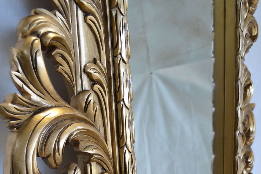 Acanthus carving detail at the left frame