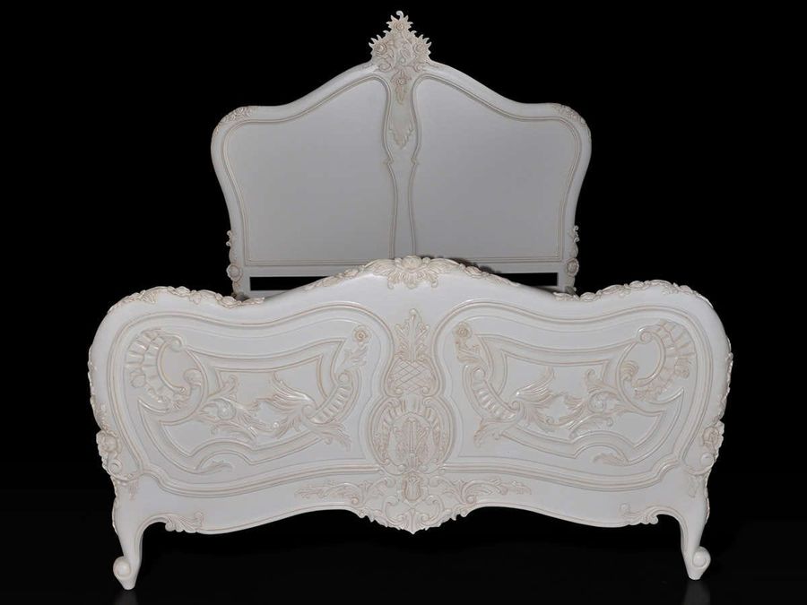 Rococo bed front view, the indentations on top and carving details of the foot board are shown.