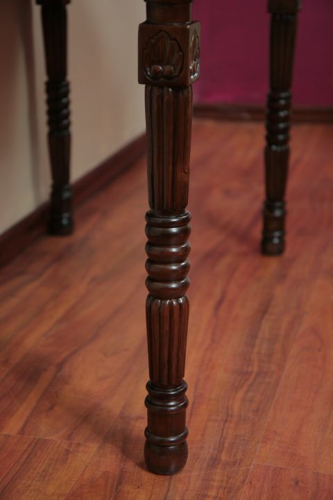 Turned wood leg detail of the colonial console table