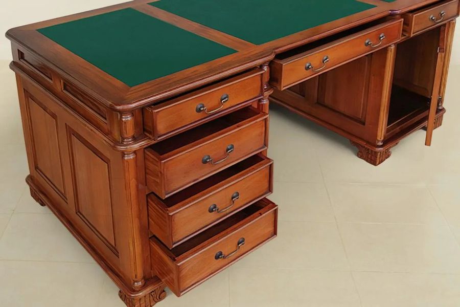 Dovetailed drawers of the Empire period partner desk pulled out