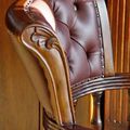 Leaf carving detail on backrest frame of Victorian swiveled chair
