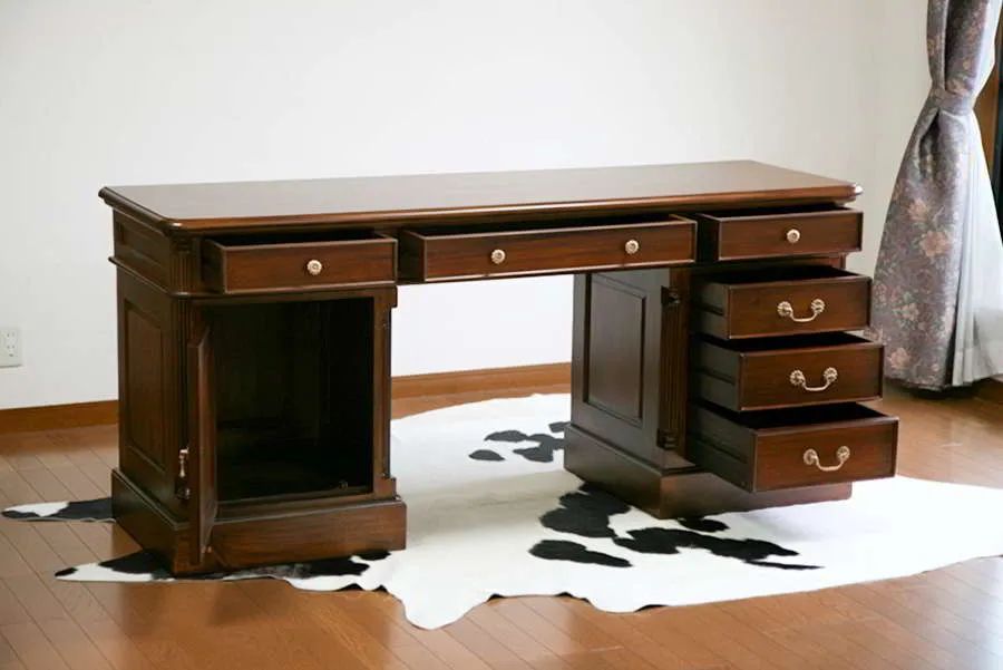 The doors and drawers of the pedestal and top section of Victorian partner desk opened