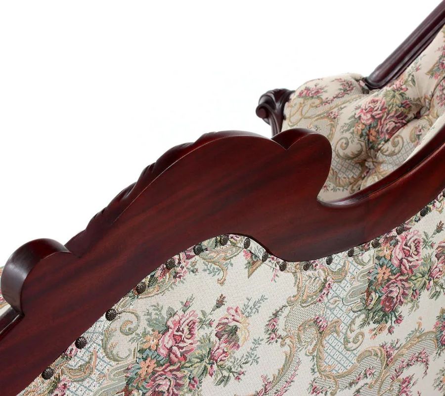 The carving detail on the backrest rails of Back side of the Victorian mahogany sofa