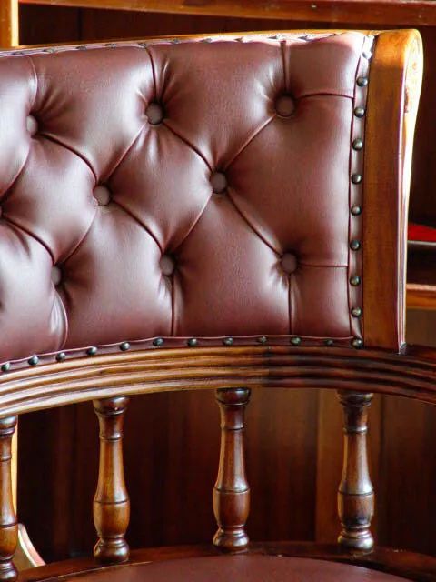Victorian swiveled office chair leather backrest detail