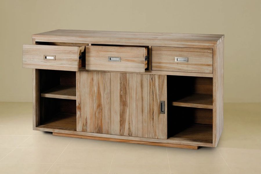 The drawers of the reclaimed teak buffet pulled out
