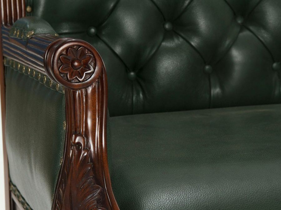 Flower carving on rounded arm rest