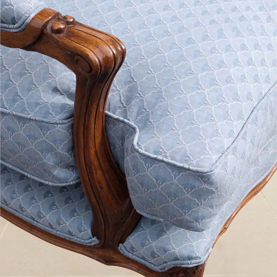 The armrest detail of the Louis XV bergere