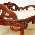 Ribbon carving and flower accent detail on the seat and legs of Rococo bedroom bench