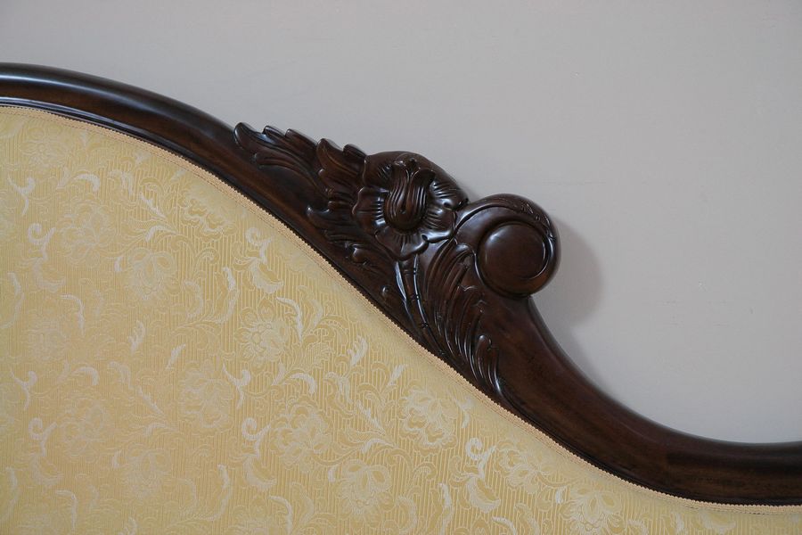 Backrest rail wood carving and upholstery edge detail