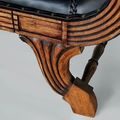 Leg and stretcher detail of the Teak leather loveseat