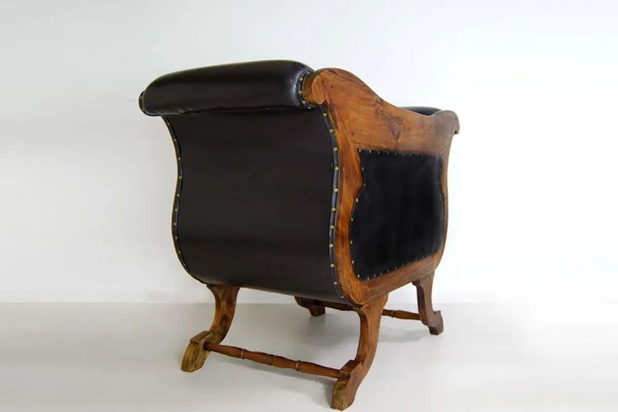 Leather detail on the side of Teak leather lounge chair