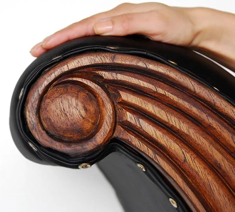 Scrolling top on the Teak leather loveseat frame