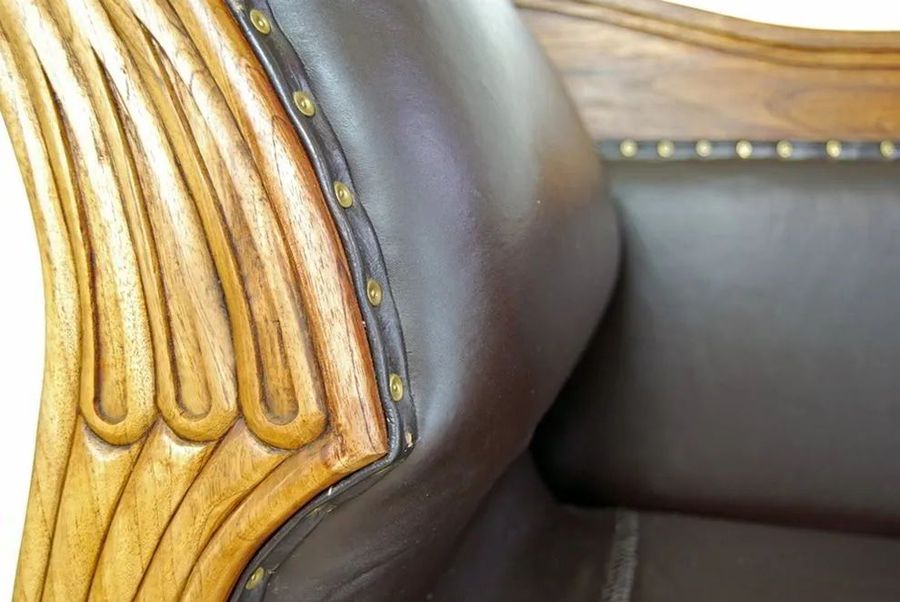 Wood carving detail on the frame of Teak leather sofa 3 seats